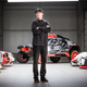 Ken Block standing in a garage of Audi race cars